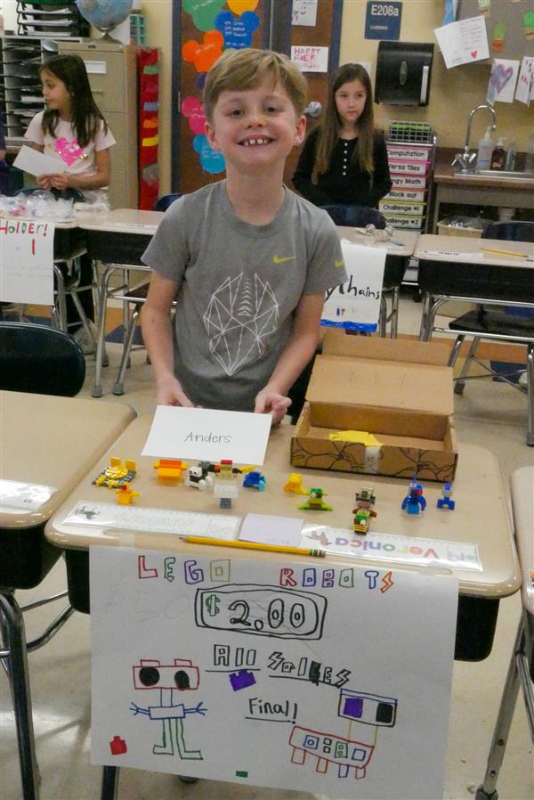 boy selling lego robots